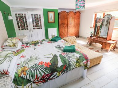 A bedroom with a bed and wardrobe at The Woodlands Lower Level in Stepaside