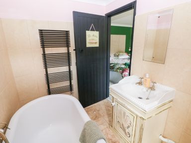 A bathroom with a bathtub and sink at The Woodlands Lower Level Stepaside