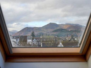 View of rooftops and hills through a skylight window at Riverside Park 6 in Keswick