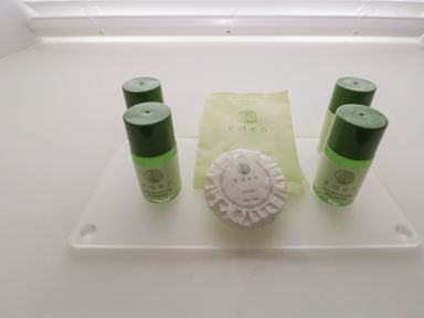 A set of small bottles and soap on a tray in a bathroom at Oxen Park Farm Cottage Oxen Park near Ulverston