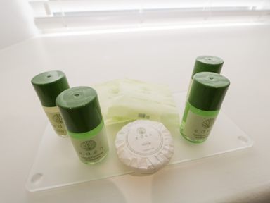 Bottles of conditioning shampoo body lotion soap and shower caps on a tray at Bills Barn in Oxen Park near Ulverston