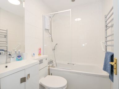 A bathroom with a bathtub and shower at Columbine Cottage in Bude