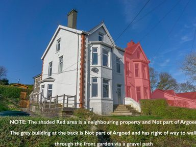 Exterior of a semi detached house with steps leading to the entrance at Argoed in Abersoch
