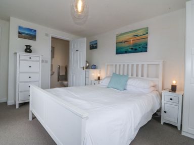A bedroom with a bed and nightstand at Bryn Awel in Mynytho near Abersoch