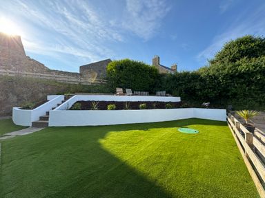 A garden with steps and plants at Cromlin Glas in Abersoch