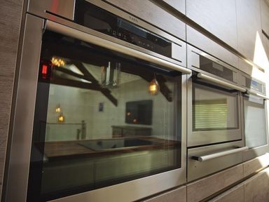 Close up of built in stainless steel ovens in a kitchen at The Barn 20 At The Beach in Torcross