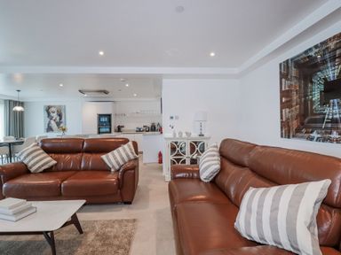 A living room with sofas and a coffee table at 13 Cliff Edge, Newquay