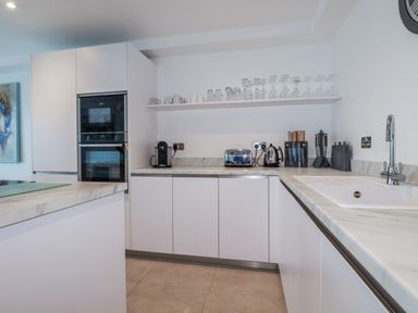 A kitchen with modern appliances and a countertop at 13 Cliff Edge in Newquay