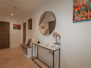 A hallway with a mirror and a table at 13 Cliff Edge Newquay