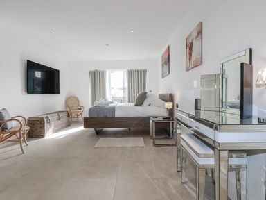 A bedroom with a bed and television at 13 Cliff Edge in Newquay