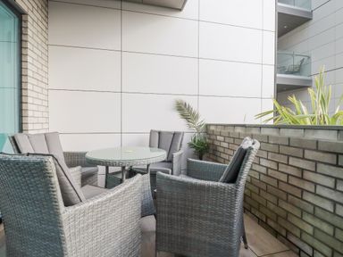 A balcony with a table and chairs at 13 Cliff Edge Newquay