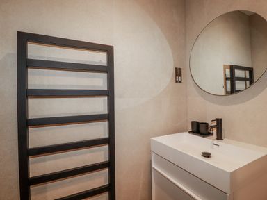 A bathroom featuring a sink and a towel radiator at 13 Cliff Edge in Newquay