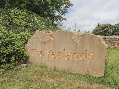 A stone sign with pure leisure The Yealands text surrounded by grass and plants at South Lakeland Leisure Village near Carnforth