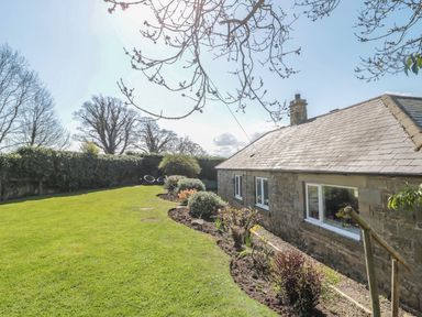 A house with a garden and trees at Whinney Moor in 