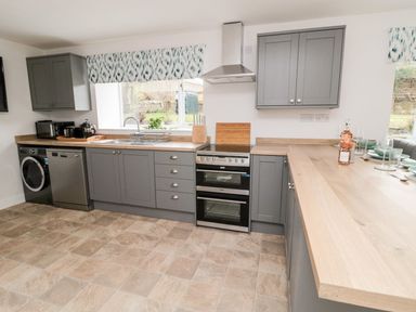 A kitchen with cabinets, sink, oven and dishwasher at Whinney Moor