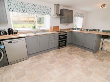 A kitchen with appliances and dining area at Whinney Moor in 