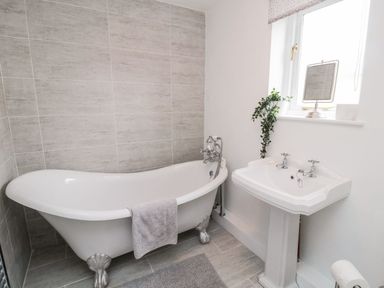 A bathroom with a bathtub and a sink at Whinney Moor 