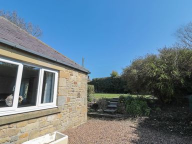 A view of a garden with steps and a stone wall at Whinney Moor