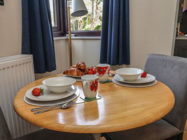 A dining table set with bowls, cups, and croissant at Bugle Saltburn-By-The-Sea