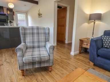 A living room with an armchair and a sofa at Bugle in Saltburn-By-The-Sea