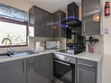A kitchen with cabinets, sink, microwave, and stove at Bugle in Saltburn-By-The-Sea