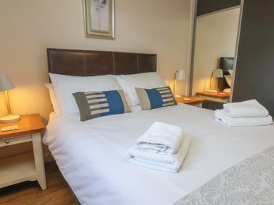 A bedroom with a bed and bedside tables at Bugle Saltburn-By-The-Sea