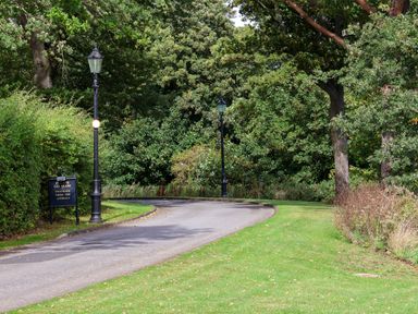 A pathway with lamp post and sign in a park at Bugle Saltburn-By-The-Sea