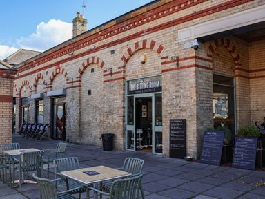An outdoor seating area with tables and menus at The Sitting Room in Saltburn-By-The-Sea