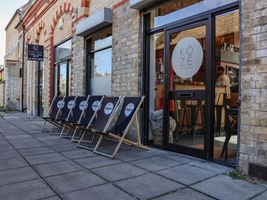 A deck area with chairs in front of a restaurant at Lavender Lodge in Saltburn-By-The-Sea