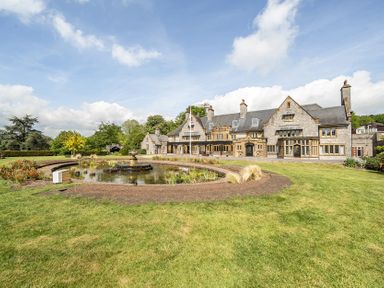 A house with a pond and garden at Harcombe House Pet Friendly Bungalow in Chudleigh