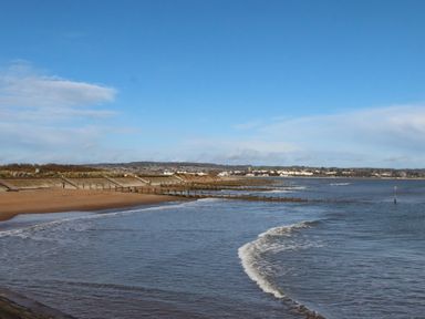 A beach with water and sand at Harcombe House Pet Free Bungalow in Chudleigh