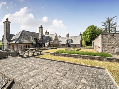An outdoor area with a patio and garden at Harcombe House Pet Free Bungalow in Chudleigh