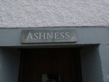 A sign with the word Ashness above a doorway at Ashness in Bassenthwaite near Keswick