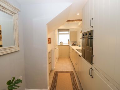 A kitchen with cabinets and a sink at 1 Tower House Cartmel
