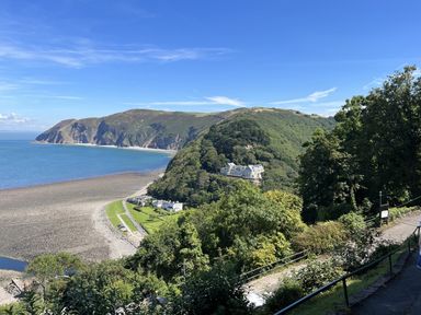 A coastal view with cliffs and buildings at Hazel Barn in North Molton