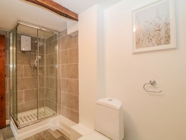A bathroom with a shower enclosure and a toilet at Oak Cottage in North Molton