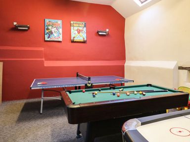 A game room with a pool table ping pong table and air hockey table at The Hawthorns in North Molton
