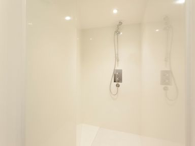 A shower area with a handheld showerhead and controls at Crablake Farmhouse in Exminster