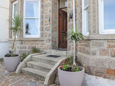 Entrance with stone steps and two potted plants on either side at Heron St Ives