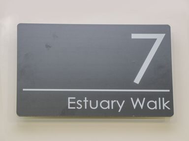 A door number sign with the number 7 and Estuary Walk