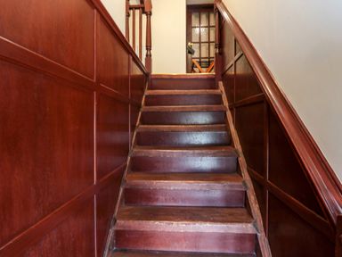 A wooden staircase with wooden paneling on the walls at The Granary in Longhirst near Morpeth