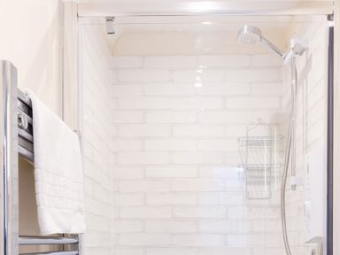 A shower with a towel rack and showerhead at White Stones in Fulbrook, near Burford