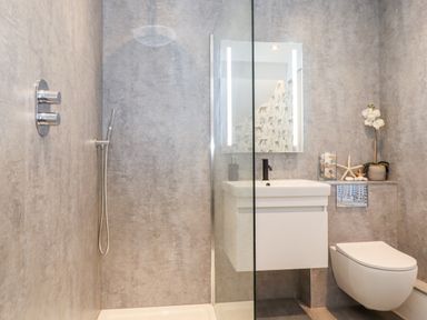 A bathroom with a shower area a sink with a mirror and a toilet at Fenty's in Bowness-On-Windermere