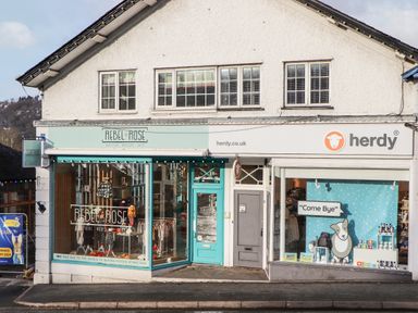 The exterior of two adjacent shops rebel rose boutique nursery shop and herdy retail store