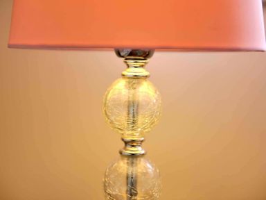 A close up of a lamp with a pink lampshade at House on the Green in Chipping Norton