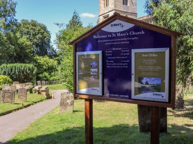 A notice board with church service times and group information outside St Marys Church in Chipping Norton