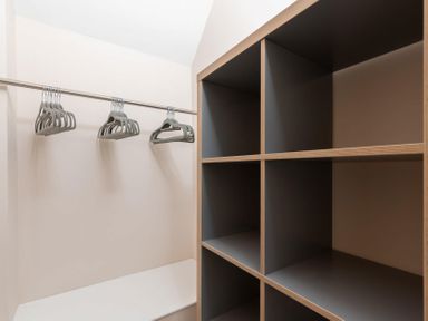 A closet with empty hangers on a rod and empty shelves at Mount View in Childswickham