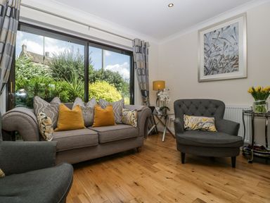 A living room with a sofa and armchair at Bell Garden in Stow-On-The-Wold