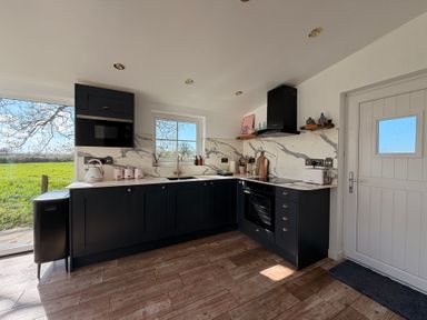 A kitchen with cabinets and appliances at Pensarngerrig in Rhydlewis