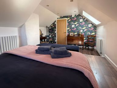 A bedroom with a bed and a desk at Pensarngerrig in Rhydlewis